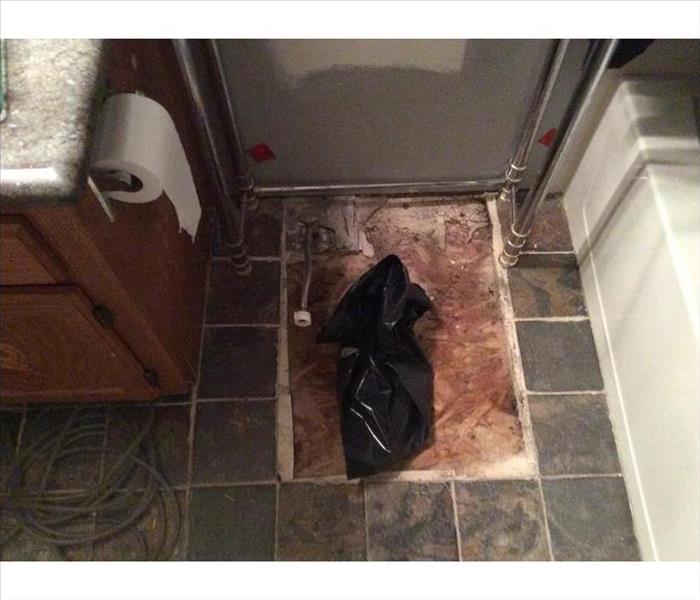 removed tiles, toilet, and bagged sewage drain in bathroom
